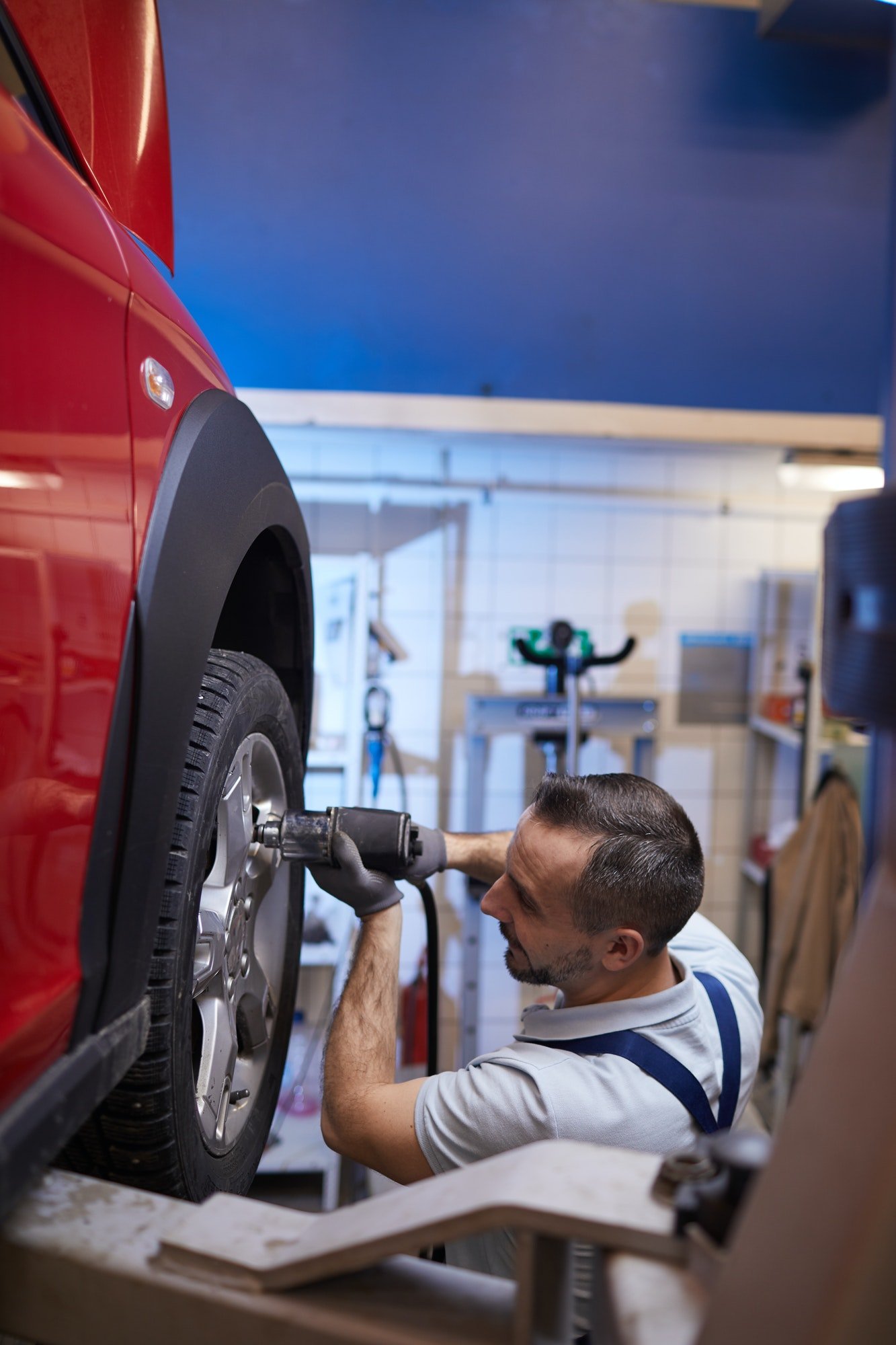 Mechanic Changing Tires in Auto Shop